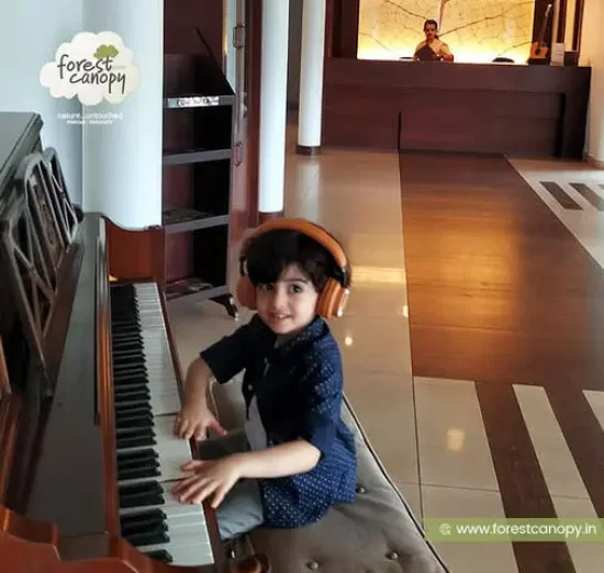 Kid reading keyboad at forest canopy resort,Thekkady, kerala